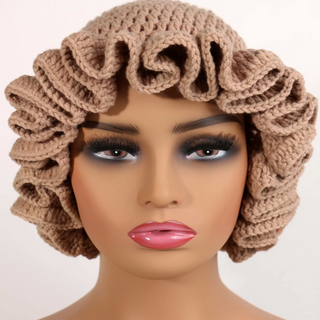 Brown crochet bonnet on a mannequin head with a plain background
