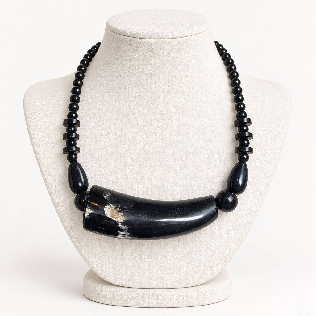 Short black horn necklace on an ivory display bust