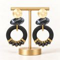 Black and gold-tone beaded statement hoop earrings