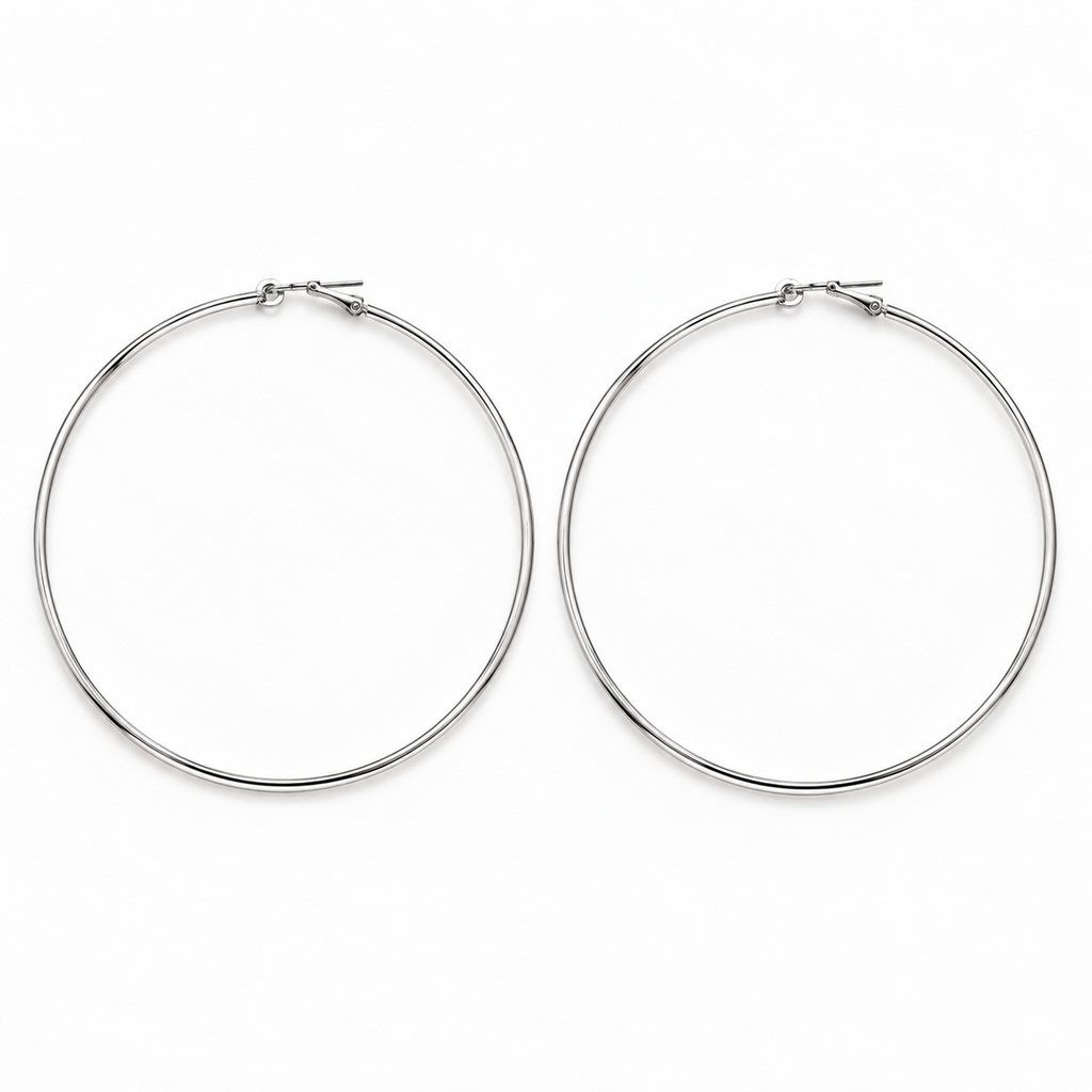 Large slim silver-tone hoop earrings lying flat side by side