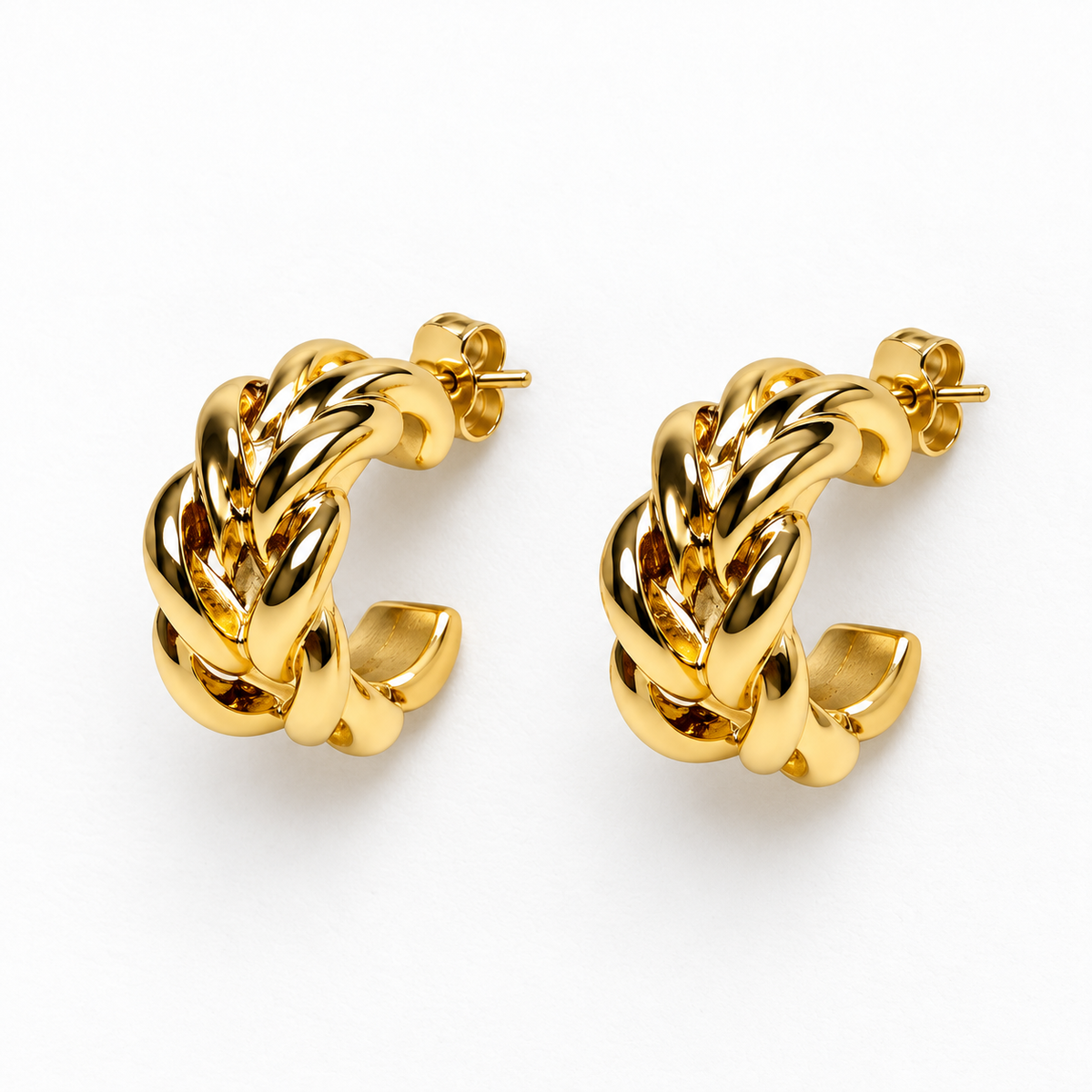 Small gold-tone braided open hoop earrings lying flat