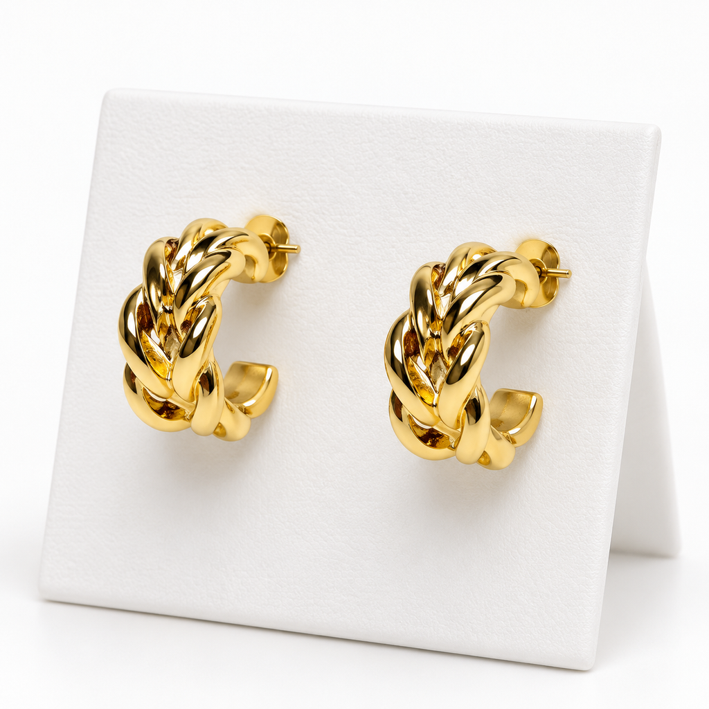 Small gold-tone braided open hoop earrings with post backs on a white holder