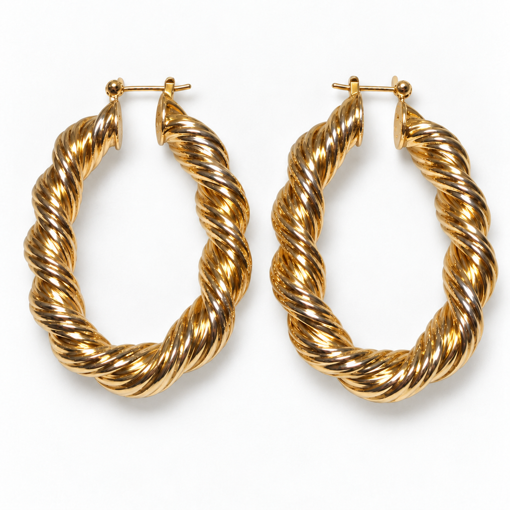 Gold-tone twisted oval hoop earrings laid flat on a near-white background