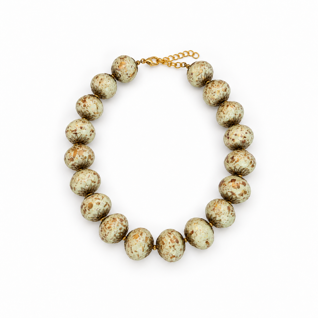 Ivory speckled beaded necklace laid flat