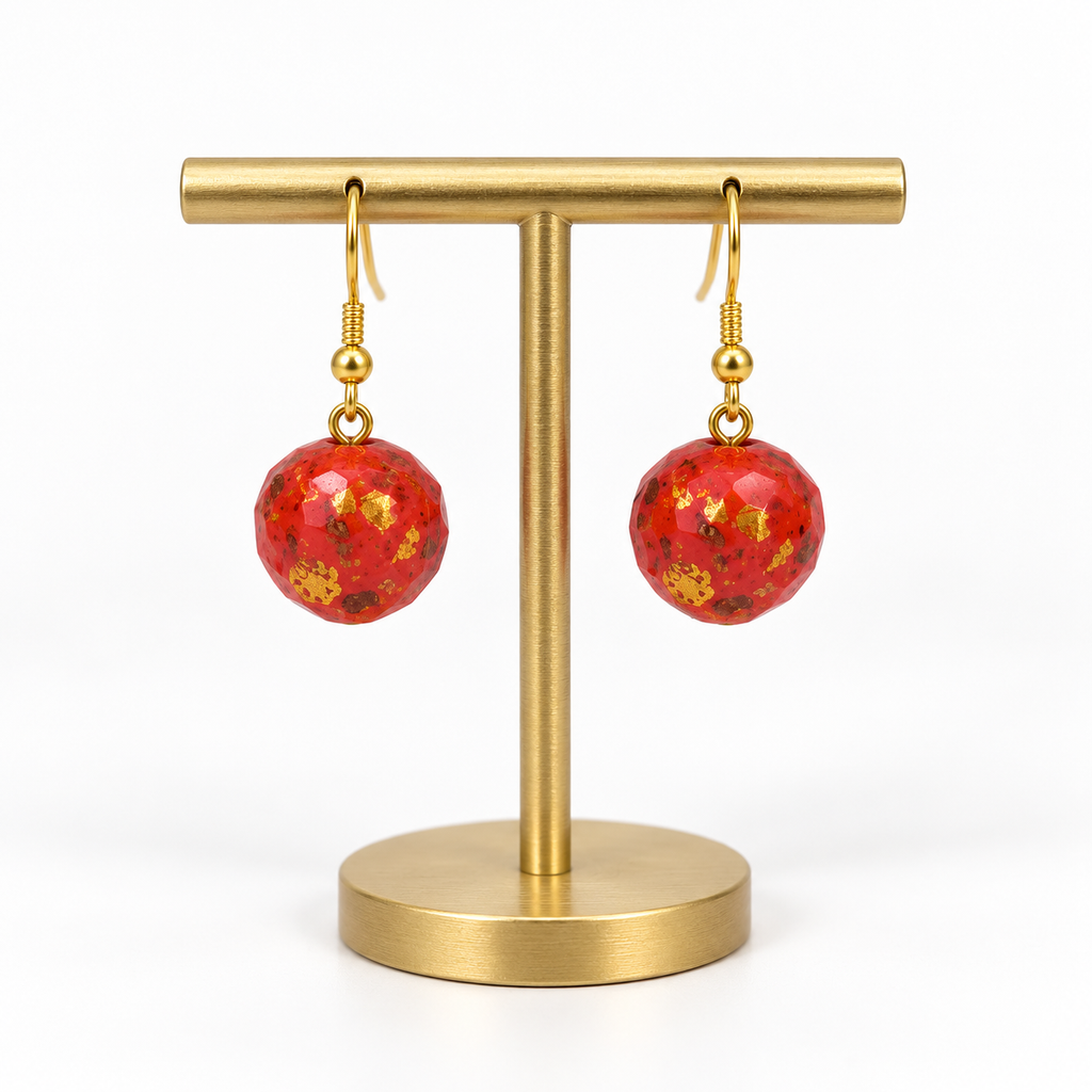 Matching red speckled fishhook earrings on a small holder