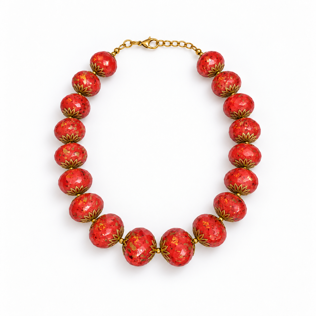Red speckled beaded necklace laid flat