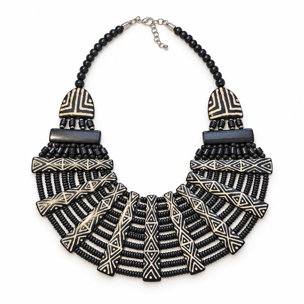 Complete black and cream geometric bib necklace laid flat within a square frame