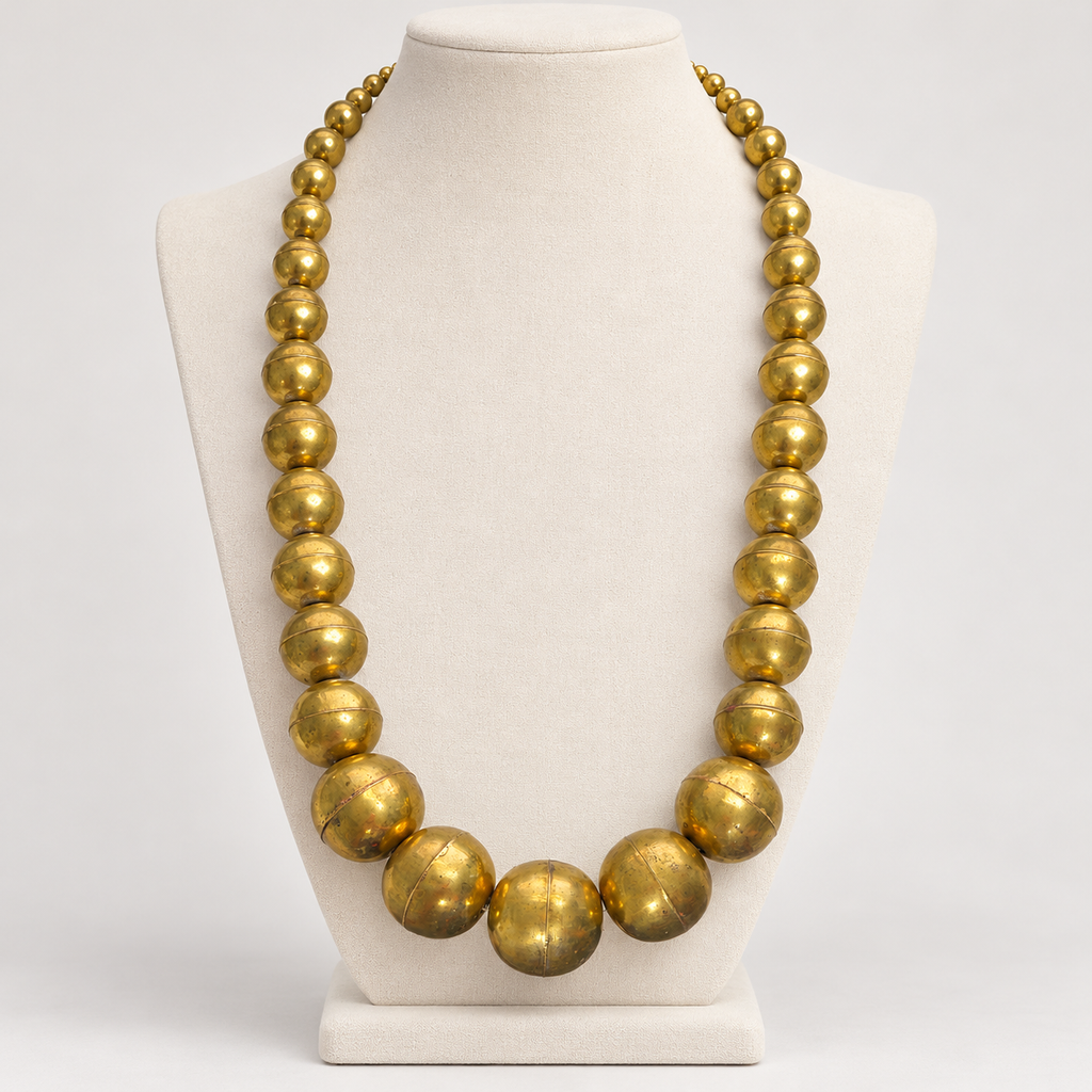 Large vintage brass ball necklace, displayed on a bust
