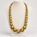 Large vintage brass ball necklace, displayed on a bust