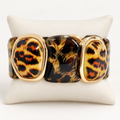Leopard print stretch bracelet on an ivory cushion