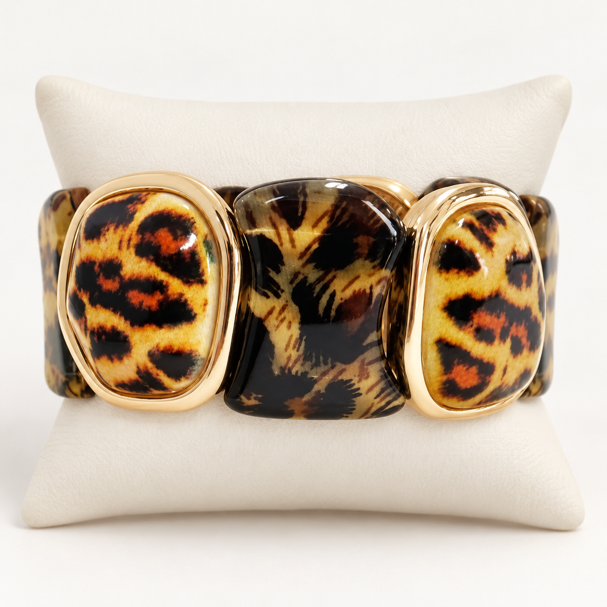 Leopard print stretch bracelet on an ivory cushion