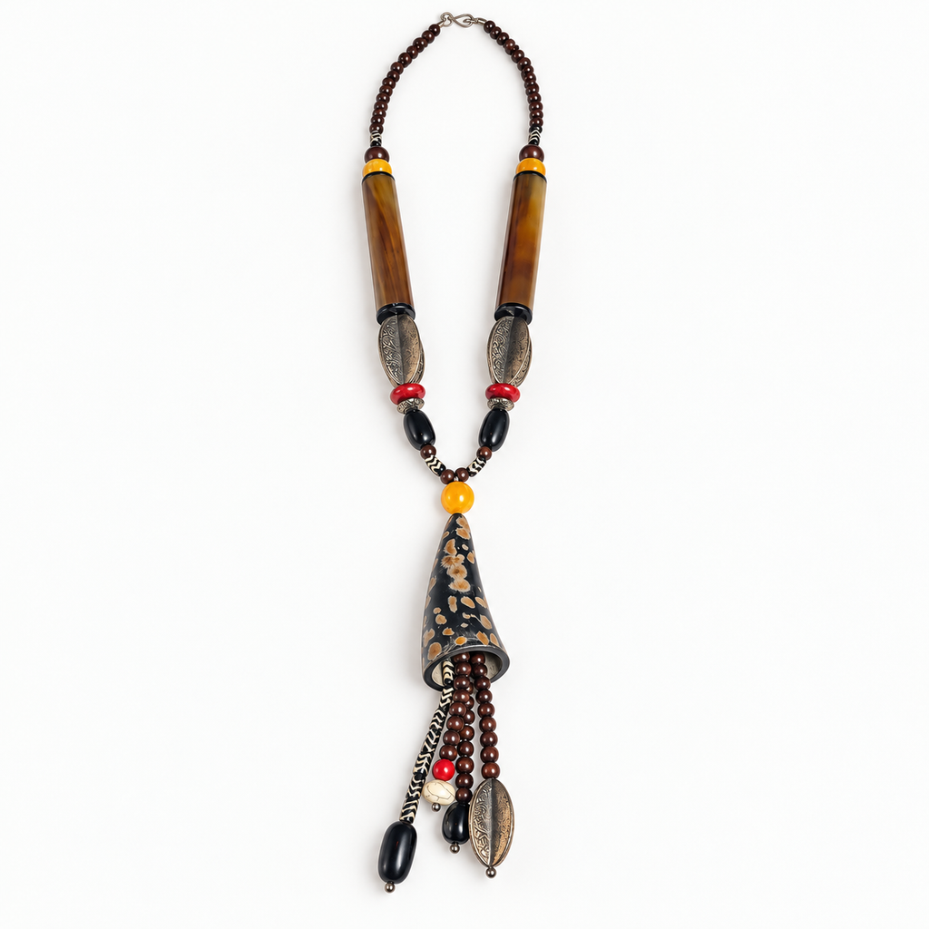 Long horn necklace with beaded dangles laid flat on a light background