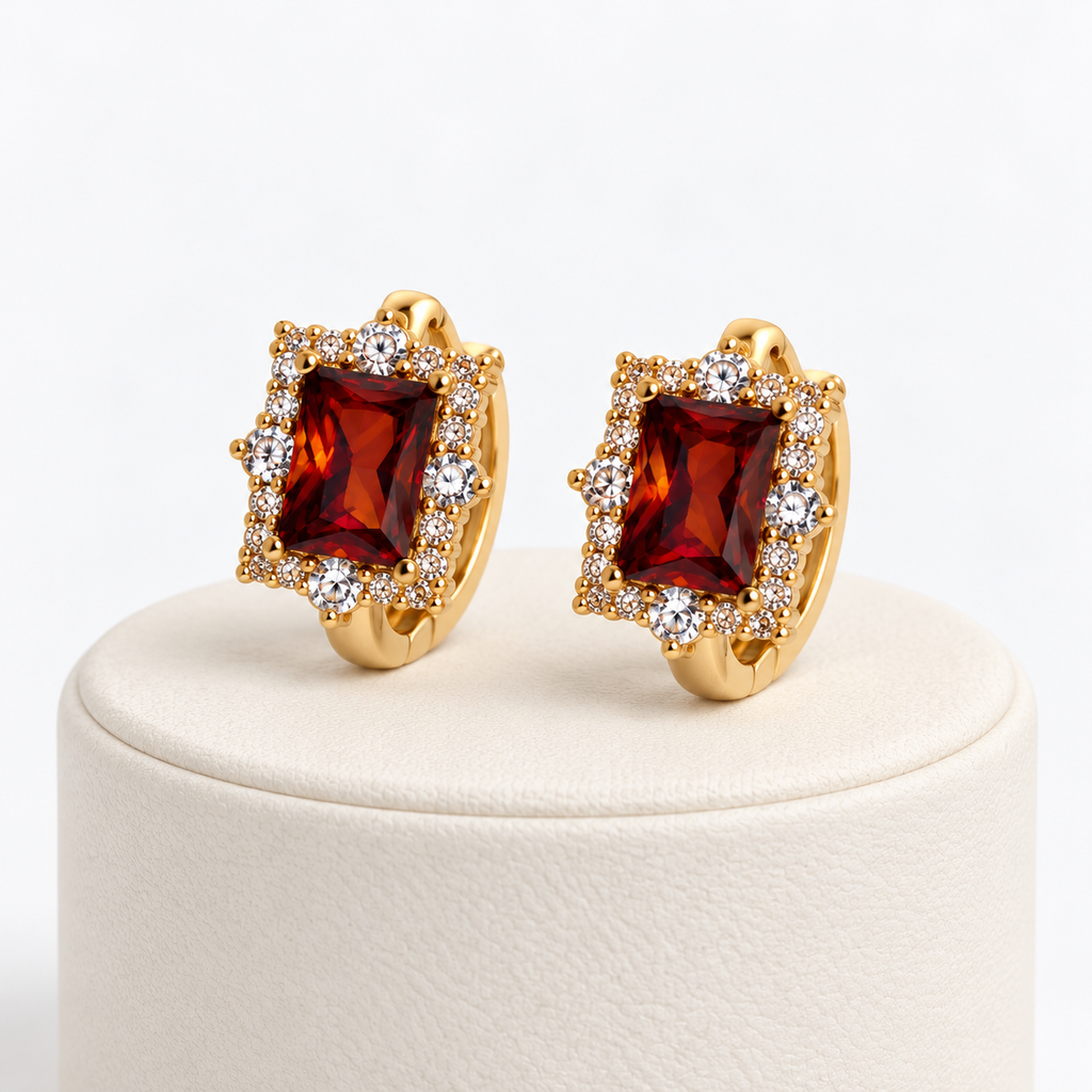 Amber rectangular halo gemstone huggie earrings on an ivory pedestal