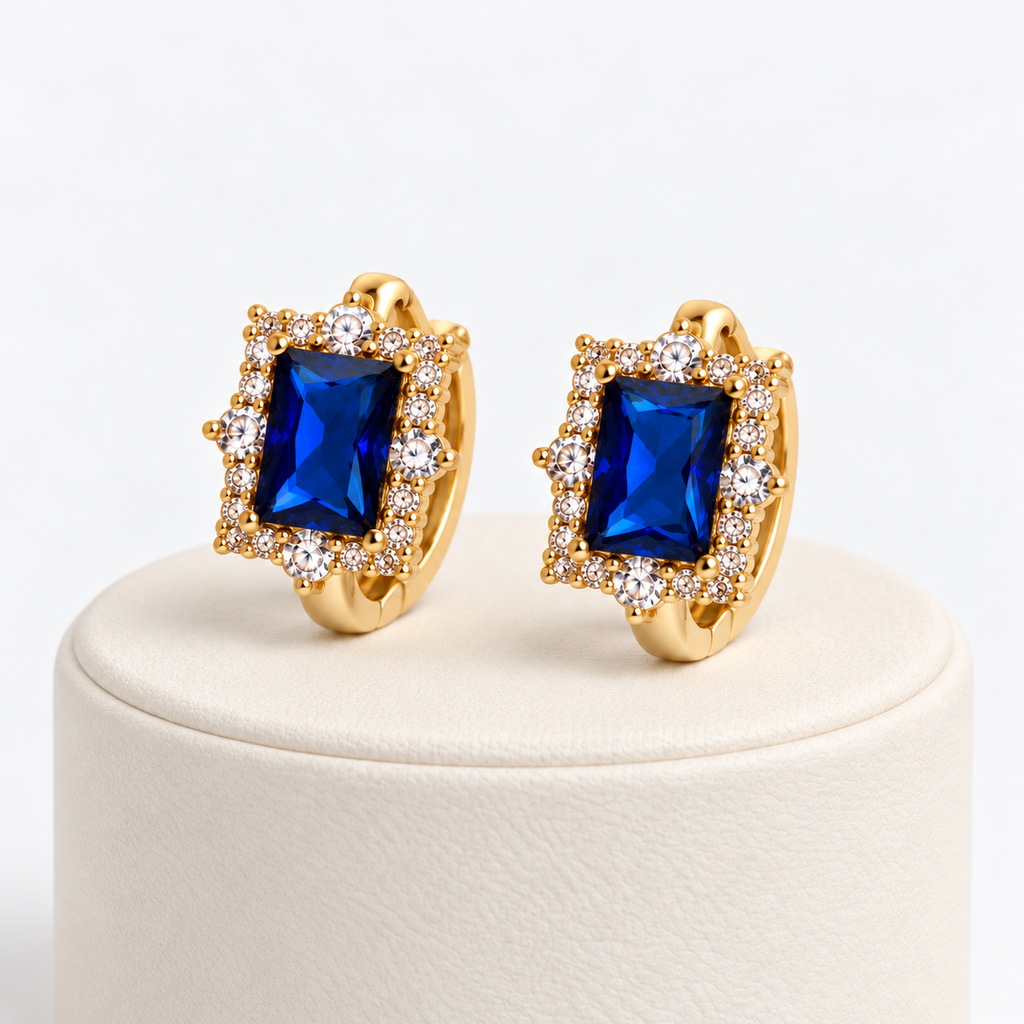 Navy blue rectangular halo gemstone huggie earrings on an ivory pedestal
