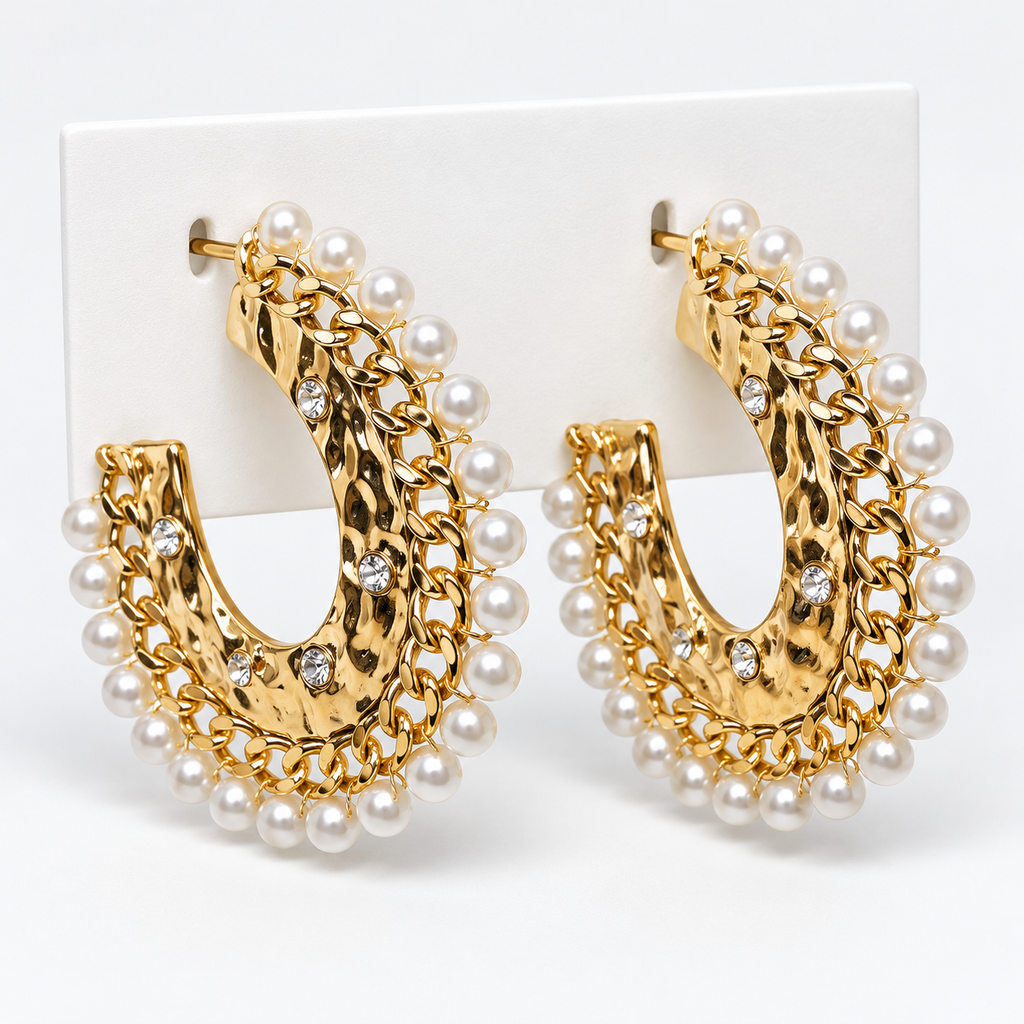 Gold-tone hammered open hoop earrings with white pearl-look trim and clear stone accents on a white holder