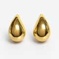 Pair of polished gold-tone teardrop stud earrings on a white surface