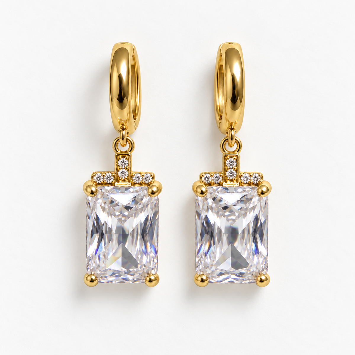 Gold and clear rectangular gemstone drop huggie earrings, flat view
