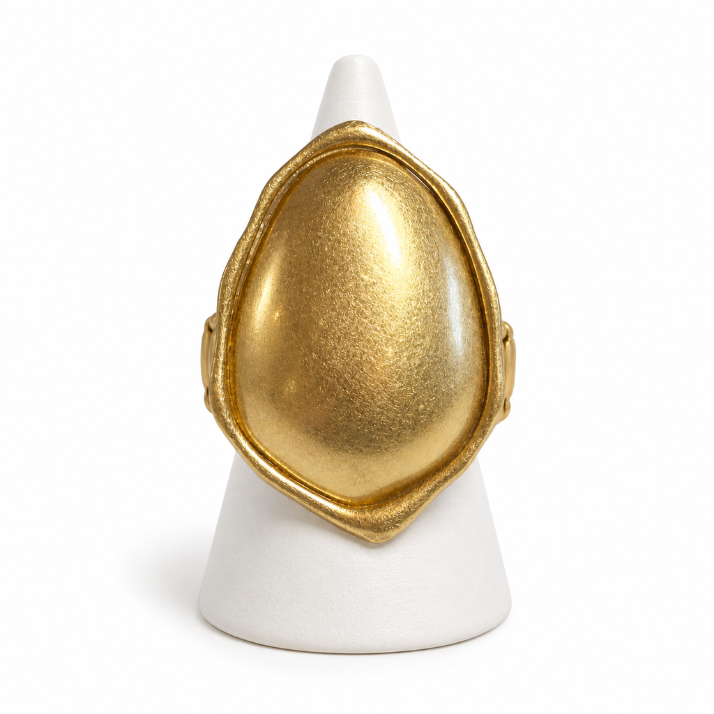 Gold-tone Sculpted Metal Stretch Ring displayed on a white ring stand