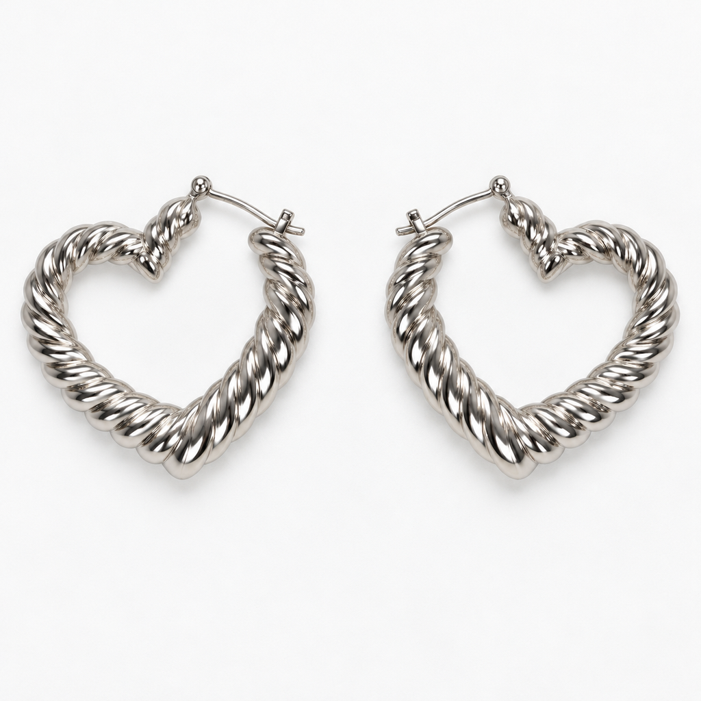Silver-tone ribbed heart-shaped hoop earrings lying flat side by side