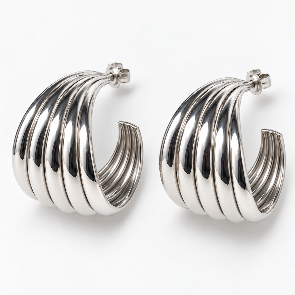 Silver-tone ribbed open hoop earrings lying flat, showing the sculpted bands and post backs
