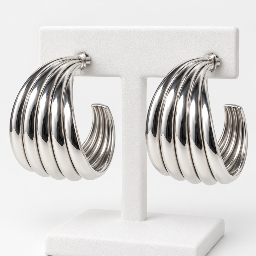 Silver-tone ribbed open hoop earrings with post backs on a white holder