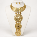 Gold-tone collar necklace with three graduated sunburst medallions on an ivory bust
