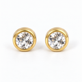 Pair of diamond (clear) round faceted stainless steel stud earrings in gold-tone bezel settings