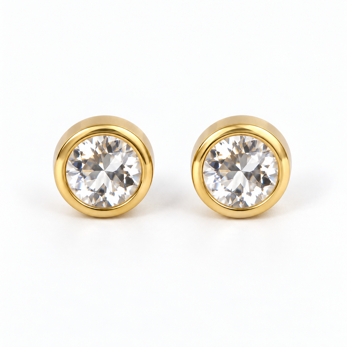 Pair of diamond (clear) round faceted stainless steel stud earrings in gold-tone bezel settings