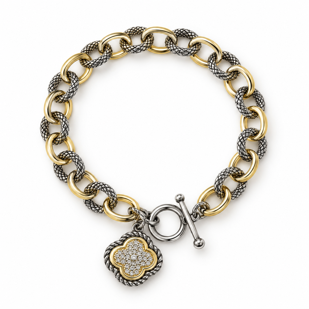 Flat view of two-tone clover charm link bracelet with toggle clasp