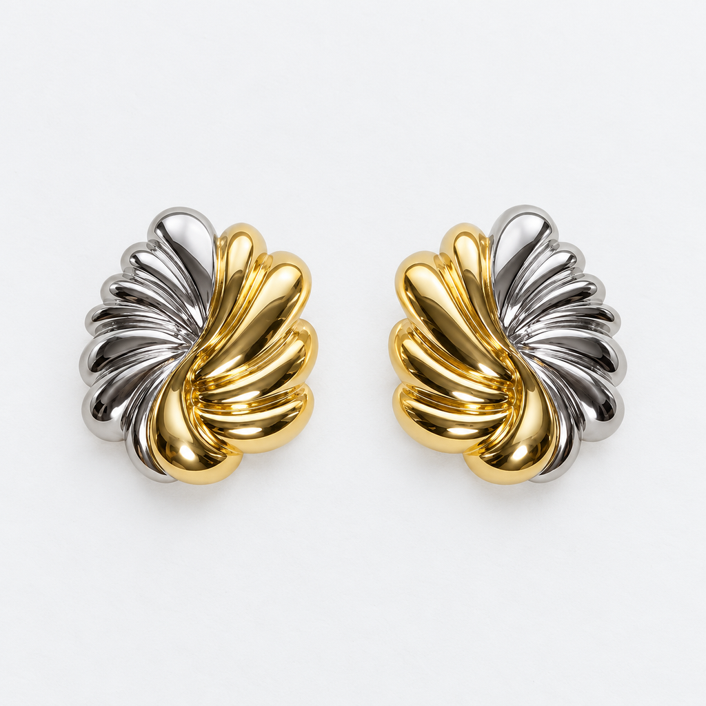 Pair of sculpted gold-tone and silver-tone leaf post-back stud earrings laid flat