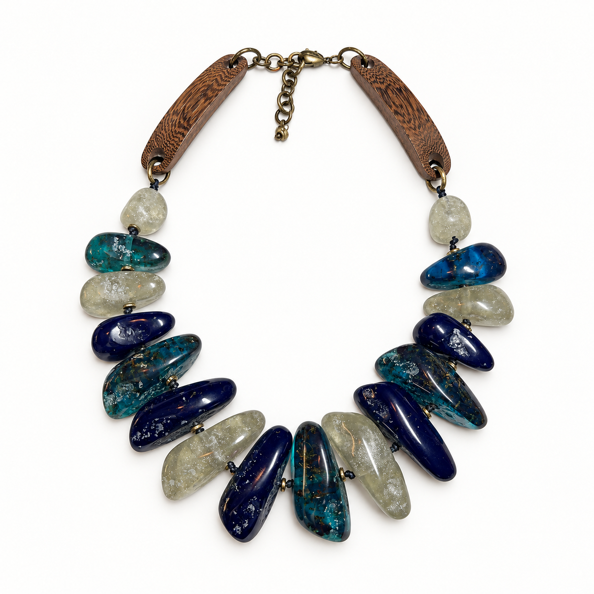 Blue hand-tied wood and chunky resin necklace laid flat in a square frame